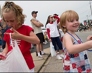 7.4.2008
Hannah Fryfogle (7), of Austintown, sorts through her candy and Cadence Pounds (4), also of Austintown, plays with a new necklace while others watch the Austintown Fourth of July Parade pass by on Raccoon Road, Friday afternoon.