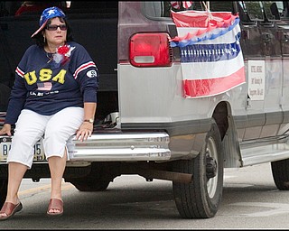 7.4.2008
Janet Pence, of Austintown, rides along on the back of a van decorated by Bethel Assembly of God during Austintown's Fourth of July Parade.
