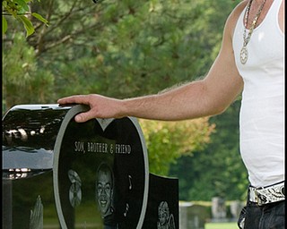 7.6.2008
Pat Harbison, of Youngstown, lays his hand on the grave of fellow motorcyclist and friend, Matthew Adam Tynal, who died July 1, 2007 from a motorcycle accident.