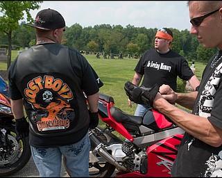 7.6.2008
Matt Rohrbaugh, of Austintown, puts his gloves back on preparing to continue on a ride involving 47 motorcycles in honor of Matthew Adam Tynal, who died in a motorcycle accident July 1, 2007. "The Lost Boyz" Motorcycle Club of Youngstown was founded in Tynal's honor.