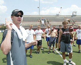 WORDS OF WISDOM: Jeff Wilkins, left, former placekicker at Youngstown State and in the NFL, gives pointers to high school-aged participants at a kickers and punters camp at Youngstown State University's Stambaugh Stadium Tuesday.