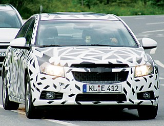 Spy photos of a camoflauged vehicle seen in Europe, believed to be the new Chevrolet Cruze.