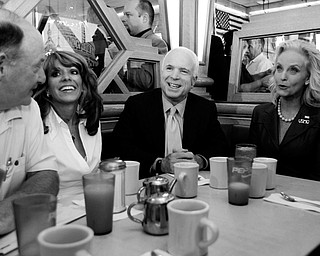 Republican presidential candidate Sen. John McCain, R-Ariz., and his wife Cindy, are joined by Lydia Gutieriez. second from left, and others, during a campaign stop at Senate Coney Island Restaurant in Livonia, Mich., Thursday, July 10, 2008.