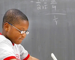 Jordan Rawl, 9, a student at Youngstown Community School, ponders a math problem during a 4 week summer intervention program at the school Wed 7-9-08. The program stresses math and reading skills to improve test scores and foster a love of learning. About 45 students participated in the program.