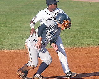 SCRAPPERS - LAKE MONSTERS - (28) Isais Velasques of the Scrappers gets tangled up with (25) Derek Norris after a hard slide at second Thursday night at Eastwood Field.