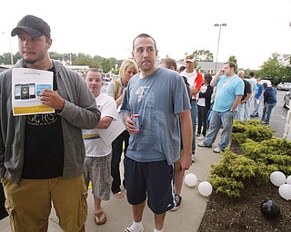 Tim Lockso, left, of Hubbard and Doug McClintock of Boardman were among a group of people lined up outside the AT&T store in Boardman Friday to purchase iPhones. Some waited overnight in parking lot.