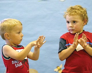 Michael Gensamer, 3, of Ellsworth, left. and Matthew Vitelli, 4, of Austintonwn make butterfly motions during a Friday 7-11 program on butterflies at the Ford Nature Center in Mill Creek Park.