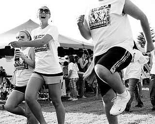 [7.11.2008]
Jay Jorge (right), of Struthers, skips through Poland's 1st Annual Relay for Life alongside Tiffany Martin (center), of Boardman, and Ashley Kozic (left), of Lowellville. The three attended the event as team members from New Life Church.