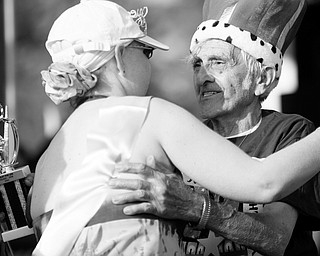 [7.11.2008] Roberta McCollums, of Hillsville PA, embraces Andy Fusco, of the west side of Youngstown after they are named queen and king of the 1st Annual Poland Relay for Life in Poland. "Every morning I put my feet on the floor, I thank God I've got another day," says Fusco who battled cancer in 1999 and it has since gone into remission. McCollums has six types of cancer and has been battling the illnes for 22 years. "Thats what we gotta do with cancer, keep busy," said Fusco.