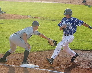 SCRAPPERS - LAKE MONSTERS - Ryan Blair of The Scrappers gets back to the bag as (4) Tyler Moore tries to make the tag during their game Thursday night at Eastwood Field.