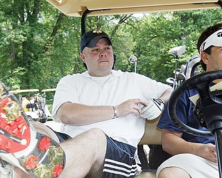 Golfers Dan Lamping, left, of Struthers and Jason Nespeca, of Youngstown, explain how high gas price and economy impact their playing of golf.