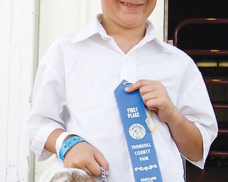 Jeremiah Adams, 10, poses with his blue-ribbon Nubian goat Ruby at the Trumbull County on Friday, July 11, 2008.