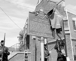 [7.12.2008] Vince Shivers, of Youngstown, unveils The Ohio Historical Society's marker recognizing St. Augustine Episcopal Chapel as a place of historical significance in the state as civil war re-enactors Steffon Jones (left) and Frederick Smith, both of Youngstown, represent the 5th USCT (United States Colored Troops) July 12, 2008. Lenora Berry chartered the church in  1907, making it the only known church in Mahoning County to have been chartered by an African American woman. Shivers began the work of requesting a marker at the church 5 years ago and is currently in the process of completing the application with the National Register of Historical Places. 