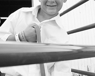 Jeremiah Adams, 10, poses with his blue-ribbon Nigerian Dwarf goat Lucky at the Trumbull County Fair on Friday, July 11, 2008.