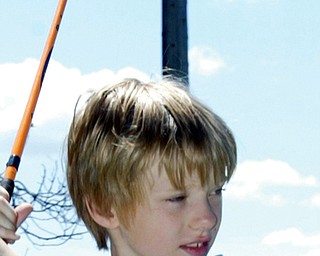 Andy Garr, 8, of Canfield tees off at Mill Creek Par 3 during Golf Camp.