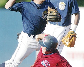 Scrappers SS Walter Diaz throws to first to turn a double. Out at 2nd is Hudson Valley's Anthony Scelfo. In background is Scrappers 2nd baseman Isaias Velasquez.