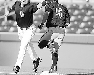 Scrappers Zach Booker misses the throw at first as Hudson Valley's Anthony Scelfo is safe at first.