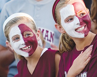 [7.15.2008] Colleen Durkin (left) Taylor Martin (right), both 9 years-old and from Boardman, listen to the playing of the national anthem before the game against visiting Canfield, at Mccune Field Tuesday night.
