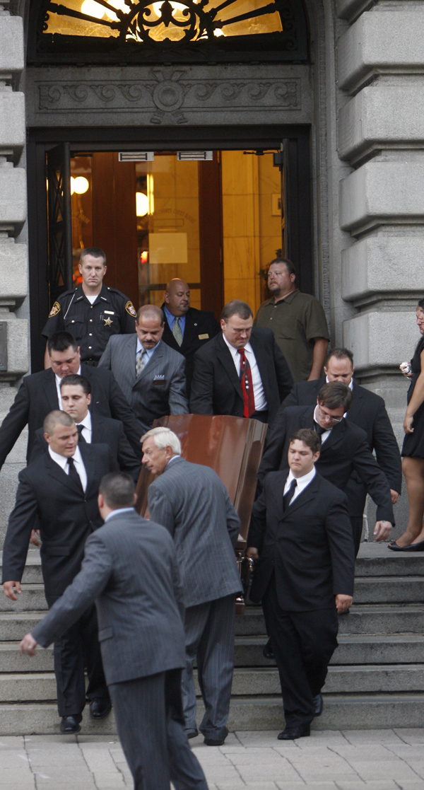 TEARFUL PROCESSION: Family members and employees from Rossi & Santucci Funeral Home carry the copper casket of Don "Bull Moose" Hanni Jr. down the steps of the Mahoning County Courthouse. Calling hours were Sunday for Hanni in the rotunda of the courthouse.