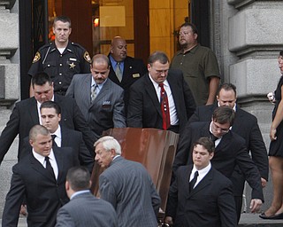 TEARFUL PROCESSION: Family members and employees from Rossi & Santucci Funeral Home carry the copper casket of Don "Bull Moose" Hanni Jr. down the steps of the Mahoning County Courthouse. Calling hours were Sunday for Hanni in the rotunda of the courthouse.