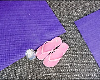 7.16.2008
Flipflops, water, and a mat at the Yoga for Kids summer workshop offered for free at Eastwood Mall by the Art Outreach Gallery and sponsored by American Gladiators Fitness Center.