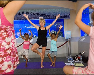7.17.2008
Judy Kay, of Howland, practices yoga with participating children during Yoga for Kids, a summer workshop at Eastwood Mall offered offered by the Art Outreach Gallery and sponsored by American Gladiators Fitness Center. "It has totally changed my life {(I began)} feeling better about life and myself, its keeping me young" says Kay of yoga which she has taught for 35 years, "thats what i want to give back to the kids and you don't need any special equipment you can do it on your own."