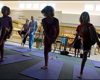 7.17.2008
Michelle Cristo and John Mrofchak, both of Warren, practice Yoga behind Zoe Bowman (7), of Vienna, Anna Cristo (8), of Warren, and Kira Bowman (8), also of Vienna, during Yoga for Kids, a summer workshop at Eastwood Mall offered offered by the Art Outreach Gallery and sponsored by American Gladiators Fitness Center.