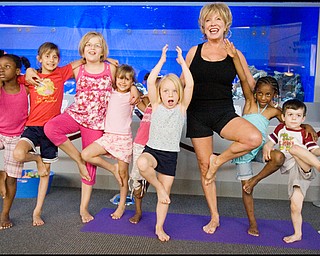 7.17.2008
Judy Kay, of Howland, practices yoga with participating children during Yoga for Kids, a summer workshop at Eastwood Mall offered offered by the Art Outreach Gallery and sponsored by American Gladiators Fitness Center. "It has totally changed my life {(I began)} feeling better about life and myself, its keeping me young" says Kay of yoga which she has taught for 35 years, "thats what i want to give back to the kids and you don't need any special equipment you can do it on your own."
