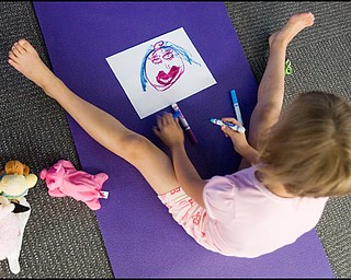 7.17.2008
Zoe Bowman (7), of Vienna, draws a picture of how she feels following a meeting of the Yoga for Kids Workshop at Eastwood Mall put on by the Art Outreach Gallery and sponsored by American Gladiators Fitness Center.