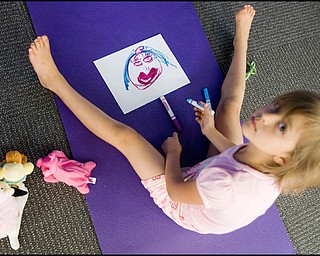 7.17.2008
Zoe Bowman (7), of Vienna, draws a picture of how she feels following a meeting of the Yoga for Kids Workshop at Eastwood Mall put on by the Art Outreach Gallery and sponsored by American Gladiators Fitness Center.