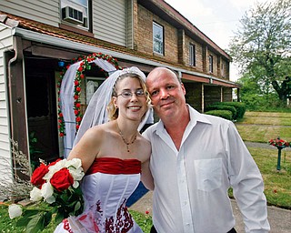 NEWLYWEDS: Robert Brooks wed Samantha Herbert at the Campbell Works company apartments, where he's lived for two years. As Samantha walked down her rose-lined sidewalk aisle toward Robert on Monday, local church bells rang int he background.