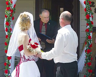 CEREMONY: Campbell Mayor John Dill conducts the ceremony of Samantha and Robert. Dill said it's nice that the former Youngstown Sheet and Tube Co. apartments are still being used and people are still moving into the buildings.