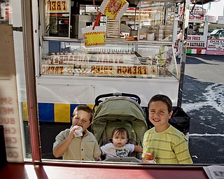 L-R Zachary Pipala, John Paul Pipala and Luke Pipala are about to order french fries to follow their snow cones at the Mt. Carmel Italian Festival in Youngstown, OH. Thursday, July 24, 2008. Daniel C. Britt.