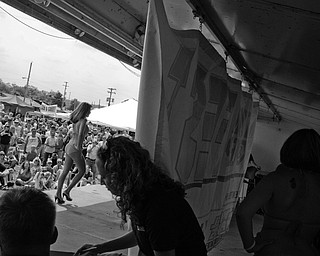 A bikini contest entree makes her way across the stage while others wait behind a tarp at the Jeep Festival held at the Canfield Fair Grounds on Sunday, July 27, 2008. Daniel C. Britt.