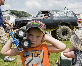 Sylas Reiheld, 3, of Stow, covers his ears when the trucks around him start revving their engines at the Jeep Festival held at the Canfield Fair Grounds on Sunday, July 27, 2008. Daniel C. Britt.