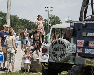 Alexis Liberatore (center, top) of North Lima and her family admires the suped-up trucks from a distance at the Jeep Festival at the Canfield Fair Grounds on Sunday, July 27, 2008. Daniel C. Britt.