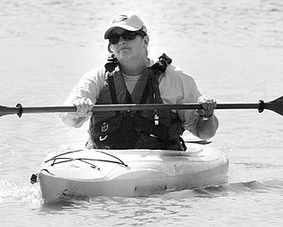 Carol Vigorito Mill Creek Park Naturalist paddles a kayak on Lake Glacier thursday during a clean-up.