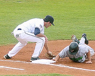 SCRAPPERS - (4) Kevin Mattison beats the throw back to the bag as Brock Simpson looses the ball Friday night at Eastwood Field. - Special to The Vindicator/Nick Mays