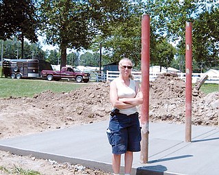 NEW PROJECT: Shannon Mosti of Highlandtown and the vice president of
the saddle horse committee at the Columbiana County Fair, stands
beside what will be come the first showers for horses at the
fairgrounds. She said that raising and caring for horses help youths
learn responsibility.