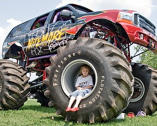 Melody Futchko, 6, of Niles plays on a tire belonging to the nightmare monster truck. At home Melody plays on her power wheels jeep. Jeep Fest, Canfield Fair Grounds on Sunday, July 27, 2008. Daniel C. Britt.