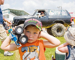 Sylas Reiheld, 3, of Stow, covers his ears, to blot out the revving truck behind him at the Jeep Festival at the Canfield Fair Grounds on Sunday, July 27, 2008. Daniel C. Britt.