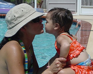 Danielle(MOM) and Adriana Trafficante(DAUGHTER) of Boardman, Ohio sharing a poolside kiss while visiting family in Tampa,  FL.  Picture taken by John Trafficante.(husband and dad)                               
