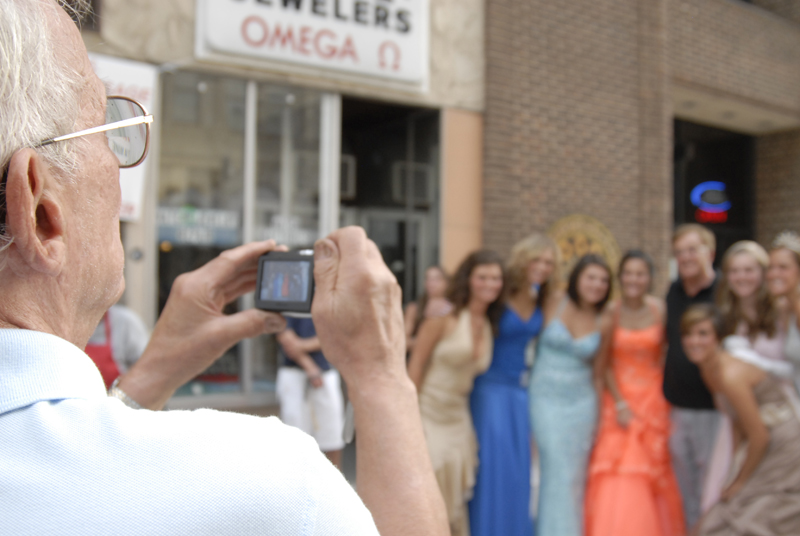 Elderly Italian men photograph one another with the girls. Daniel C. Britt. 