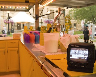 Slow traffic early in the day gave this lemonade vendor reason to leave a portable TV in charge of the stand. Daniel C. Britt.