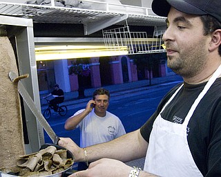 Kosta Fantidas carves gyro fresh off the spit at the Greek Delights stand set up at the Warren Italian Festival Thursday, August 7, 2008. Daniel C. Britt.