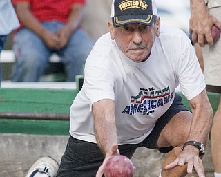 Tony Angelo of Warren throws a bocce ball in his signature style, by dropping to his padded knee and lounging forward. It took over 30 years to develop that throw, he said. Warren Italian Festival Thursday, August 7, 2008. Daniel C. Britt.