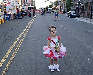 Morgan Rolley, 4, of Warren gets no comfort from her trophy while her mom steps away to buy a Gyro. Rolley was the runner-up in the Tiny Queen pageant. Warren Italian Festival Thursday, August 7, 2008. Daniel C. Britt.