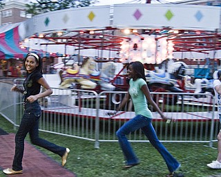 Tenacious Trio: L-R Warren residents Ashley Brown, 13, Angela Brown, 13 and McKenzie Montecalvo, 13, racing toward the next attraction at the Warren Italian Festival Thursday, August 7, 2008. Daniel C. Britt.