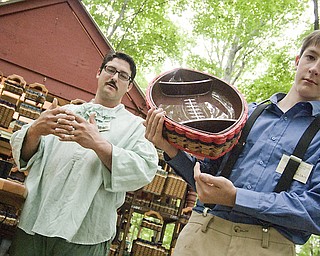 Joe Nelson, left, with his son Riley, 13, explain how some baskets are weaved to carry more load than others. Riley takes full credit, however, for the football idea. Shaker Craft Festival in Beaver Sunday, August 10, 2008.