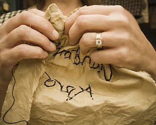 Debbie Forgac of N. Lima specializes in primitive folk art stitching. She's putting the finishing touches on an apron in her booth at the Shaker Craft Festival in Beaver Sunday, August 10, 2008. Daniel C. Britt.